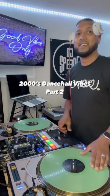 DJ SpeedE smiling behind the decks