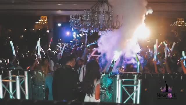 Wedding reception crowd with glow sticks and chandelier